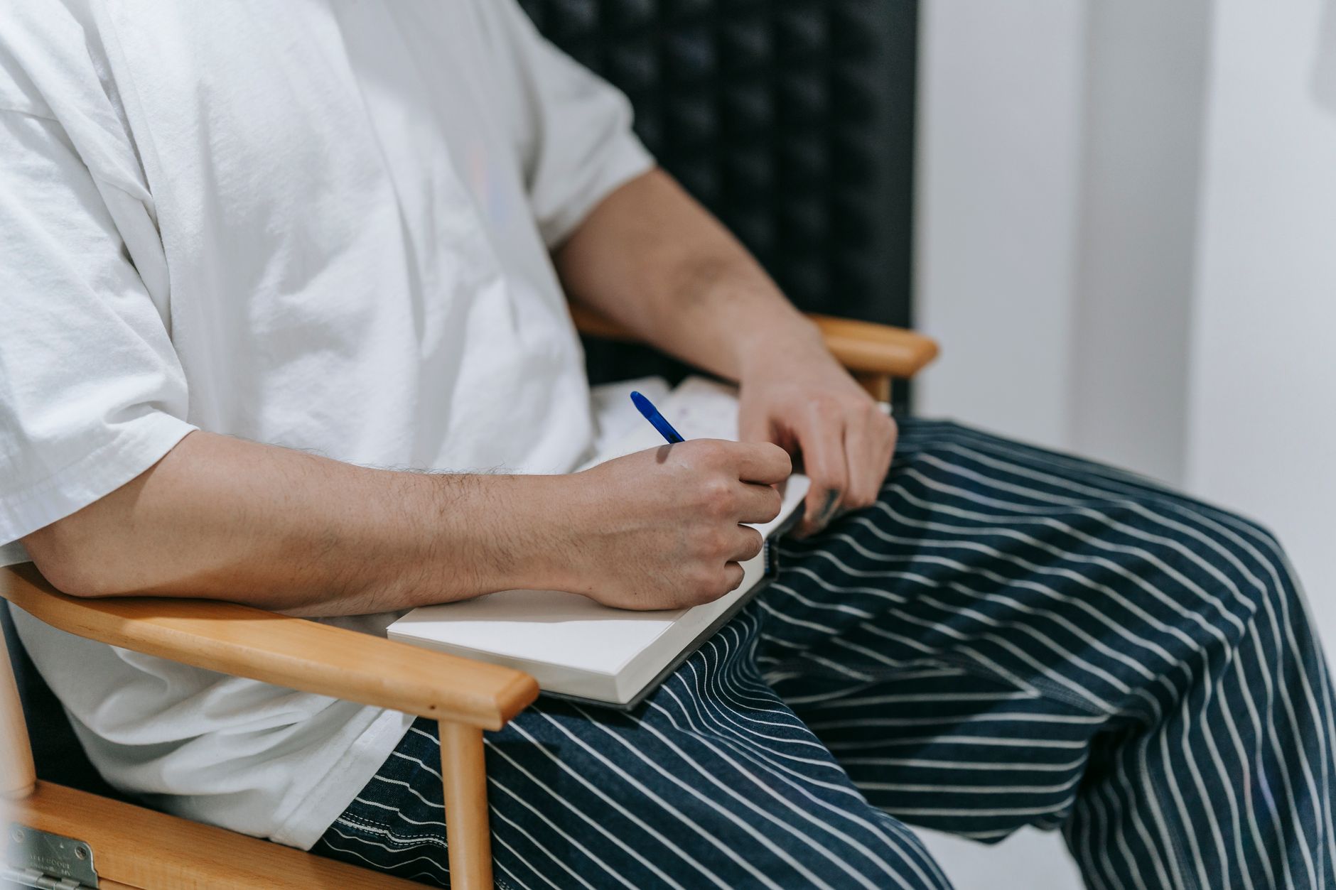 Travel writer reviewing notes on a rustic wooden balcony